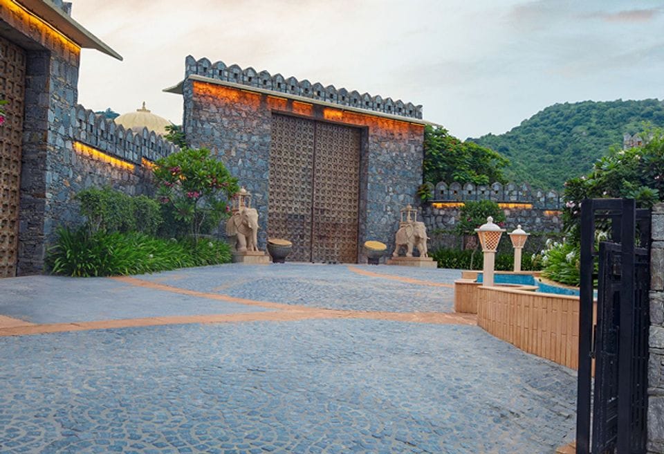 Grand stone gateway with elephant statues at a Kumbhalgarh fort-style resort entrance