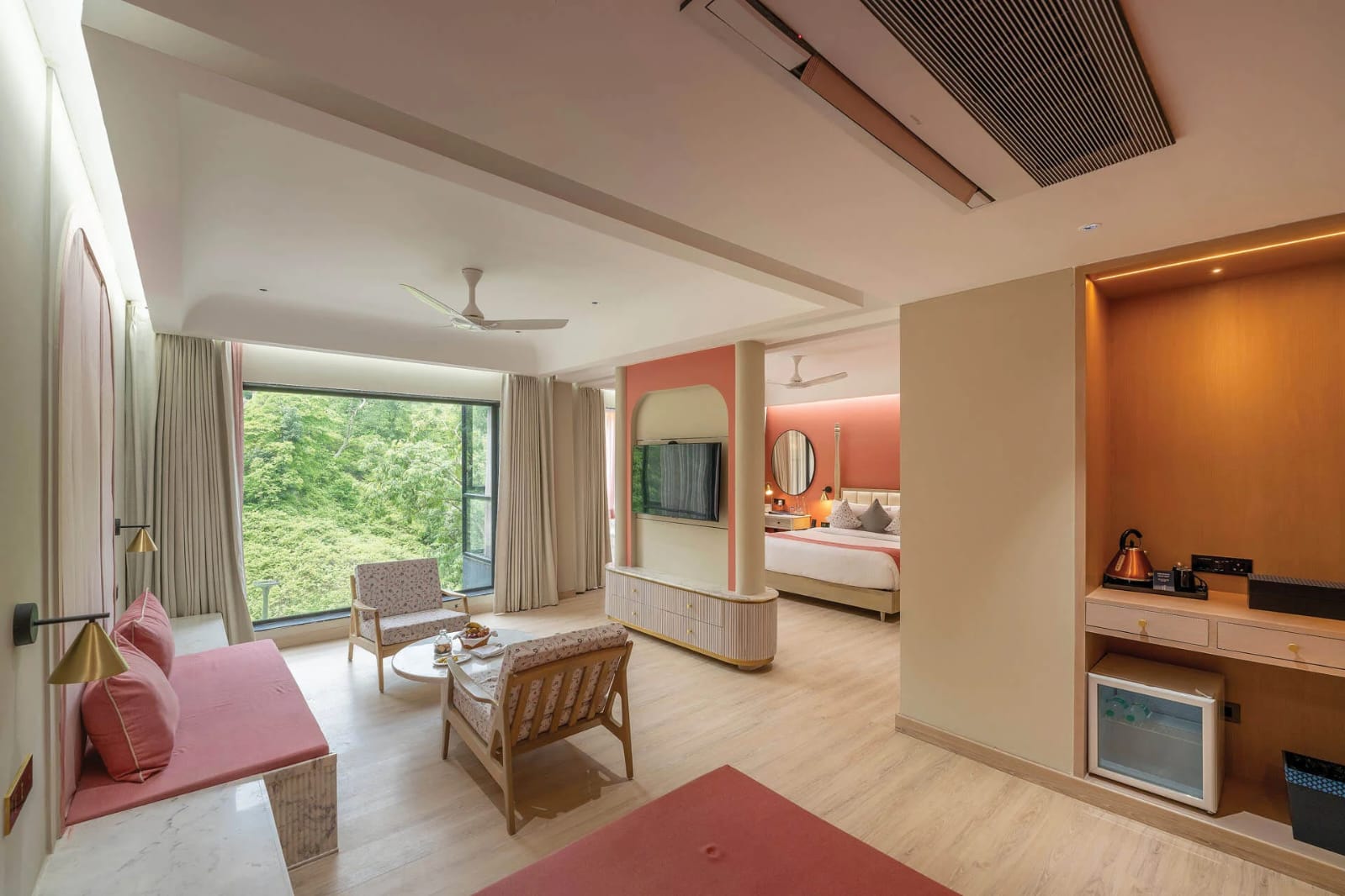 Presidential suite living room and bedroom wing with forest views